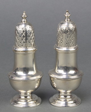 A pair of Georgian design silver shakers of plain form C J Vander London 1965 4 3/4", 190 grams