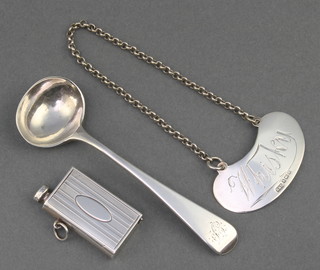 A silver salt spoon, a vesta and a whisky label