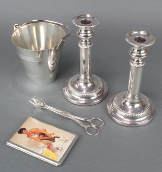 A pair of silver plated telescopic candlesticks together with an ice bucket and nips and a plated cigarette case 