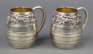 A pair of Portuguese silver baluster mugs with vinous decoration 3 1/4" 