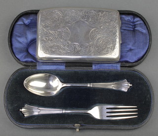 A cased silver fork and spoon Sheffield 1909 together with a silver cigarette case with chased scroll decoration Birmingham 1919 182 grams