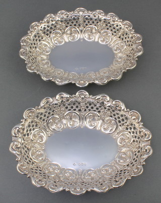 A pair of Victorian silver repousse oval dishes with scroll and pierced decoration Henry Wilkinson and Son London 1890 7 1/2" x 6", 190 grams 