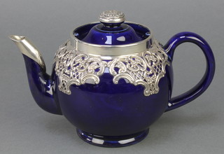 An Edwardian silver mounted Doulton teapot with repousse mounts, London 1906 