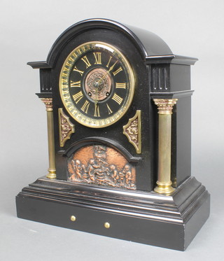 A French 8 day striking mantel clock contained in a large and impressive arched black marble case supported by gilt columns and having classical embossed panel to the centre