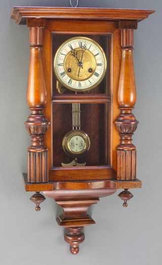 A Vienna style striking regulator, the 5 1/2" dial with enamelled chapter ring and Roman numerals contained in a walnut case with grid iron pendulum 