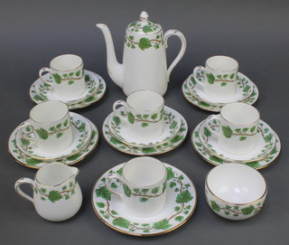 A Crown Staffordshire part coffee set decorated with leaves and berries comprising coffee pot, milk jug, sugar bowl, 6 coffee cans, 5 saucers and 6 small plates
