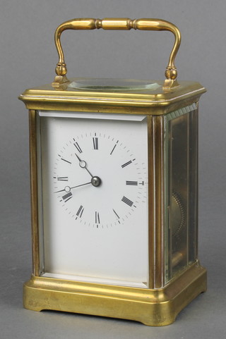 A 19th Century French 8 day carriage timepiece with enamelled dial and Roman numerals contained in a gilt metal case 5"h x 3 1/2"w x 3 1/2"d 