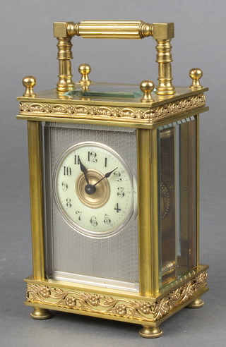 A 19th Century French 8 day carriage timepiece with circular enamelled dial and Arabic numerals contained in an ornate gilt and silvered case 5"h x 3 1/2"w x 2 1/2"d 