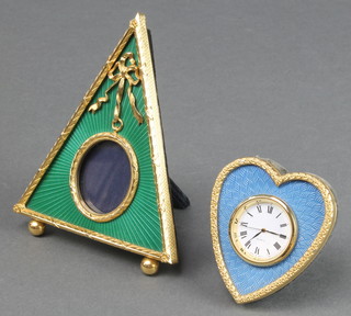 Kitney, a Faberge style gilt metal and blue enamel quartz table clock in the form of a heart 3" together with a ditto green enamel and gilt metal clock case 