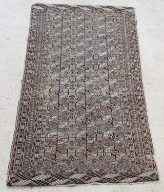 A sand ground Tekke Torkman rug with 36 octagons to the centre within multi-row border 84" x 44" 