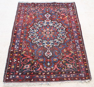 A red and blue ground Bakhtiari rug with central medallion 79" x 55" 
