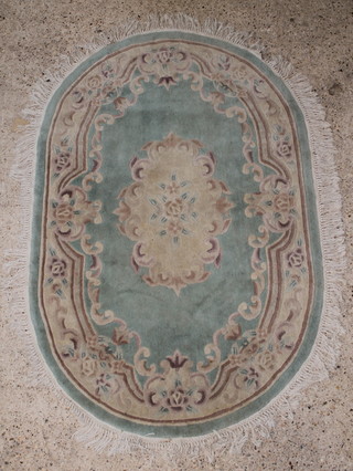 An oval turquoise and floral patterned Chinese rug 75" x 49" 