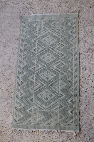 A Tunisian green ground flat weave rug 57" x 28" 