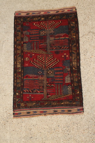 A blue and red ground Persian pictorial rug of trees and buildings 51" x 32" 