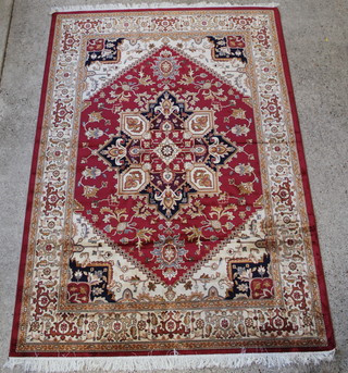 A red and cream ground Heriz rug with diamond shaped medallion to the centre 110" x 79" 