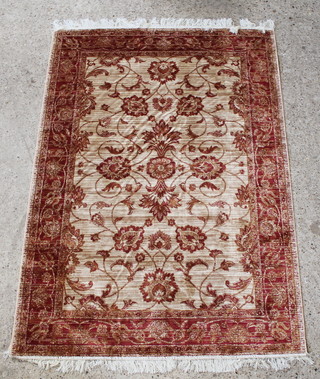A gold and copper ground Ziegler rug with floral ground 76" x 52" 