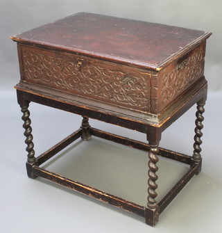An 18th Century carved oak bible box with heavily carved panels to the sides, fitted a drawer, raised on a later associated stand with spiral turned decoration 32"h x 32"w x 22"d 