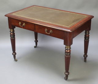A Victorian style mahogany writing table with inset writing surface, the base fitted 2 short drawers, raised on turned and reeded supports 30"h x 42"w x 26"d 