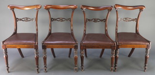 A set of 4 William IV mahogany bar back dining chairs with pierced shaped mid rails and upholstered seats, raised on turned and fluted supports 