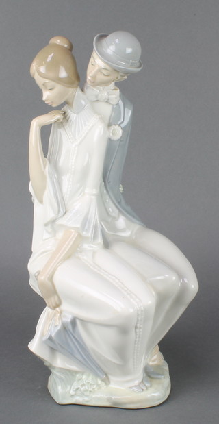 A Nao group of a seated lady and gentleman holding a bouquet of flowers behind his back 16"