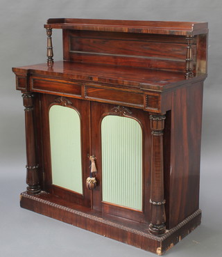 A William IV rosewood chiffonier with raised back fitted a shelf, the base fitted 2 drawers above arched panelled doors flanked by turned columns 48"h x 43 1/2"w x 19 1/2"d 