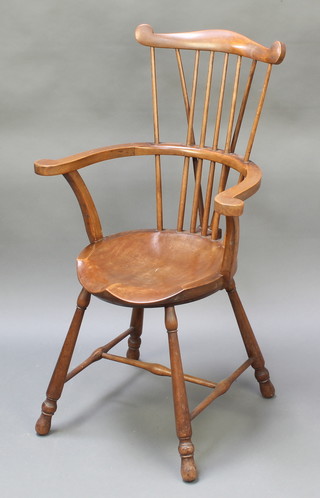 An Arts & Crafts beech framed stick and wheel back Windsor chair with H framed stretcher 