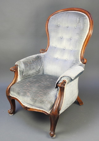 A Victorian mahogany show frame armchair upholstered in blue buttoned material, raised on cabriole supports 