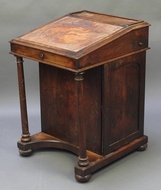 A William IV mahogany Davenport desk with three-quarter gallery, having an inkwell drawer to the side, the pedestal fitted 4 long drawers enclosed by a panelled door with turned columns to the front 31"h x 21 1/2"w x 24"d 