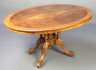 A Victorian figured walnut Loo table, the quarter veneered top with inlaid stringing raised on 4 carved columns with tripod base 26"h x 51"w x 38" 