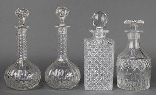 A 19th Century mallet shaped decanter and stopper 9", a pair of mallet decanters and stoppers 10 1/2" and a spirit decanter and stopper 10" 