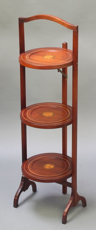 An Edwardian circular inlaid mahogany 3 tier folding cake stand 35"h x 9 1/2" diam. 