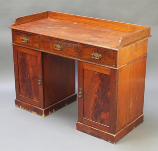 A Victorian mahogany wash stand with three-quarter gallery fitted 3 short drawers the pedestal fitted a cupboard enclosed by panelled doors 33"h x 45"w x 20"d 