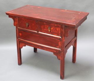 A Chinese red lacquered side table fitted 2 drawers with brass drop handles 33"h x 42"w x 21 1/2"d 