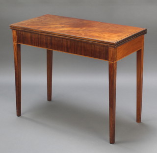 A rectangular Georgian mahogany tea table with ebonised stringing, raised on square tapered supports 28 1/2"h x 35"w x 17 1/2"d 
