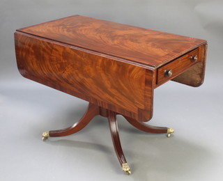 A 19th Century mahogany pedestal Pembroke table with crossbanded top fitted a drawer, raised on a pillar and tripod base ending in caps and castors 28"h x 42"w x 22 1/2" when closed x 45" when open 
