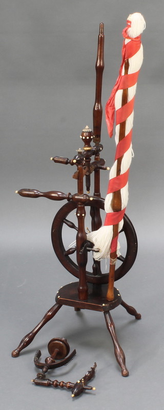 A turned fruitwood spinning wheel, some damage