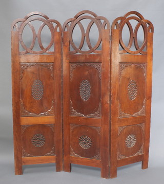 An early 20th century Indian hardwood 3 fold screen, the top surmounted by pierced rings, the panels carved with flowers and pierced decoration 72"h x 66"w x 1"d