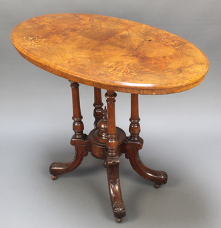 A Victorian inlaid walnut oval occasional table raised on a quatreform base with china castors 28.5"h x 36"w x 21"d