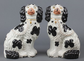 A pair of Victorian Staffordshire black and white figures of spaniels 10" 