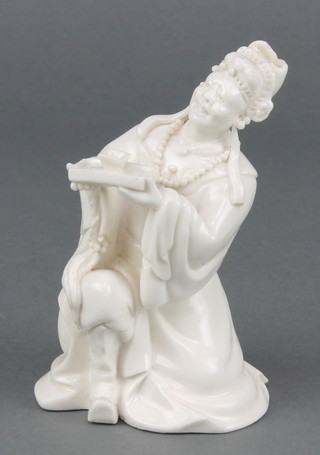 A 19th Century blanc de chine figure of a kneeling gentleman holding a tray and tea bowl 5" 