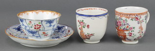 An 18th Century Chinese export tea bowl and saucer decorated with scrolling flowers, a famille rose tea cup decorated with flowers and a ditto decorated with a vase of flowers 