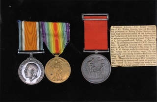 A medal group to Pte. later P.C. Ralph Adkins George, comprising British War and Victory medal to 3255 Pte. R.A. George E.K.R. together with bronze Medal of the Society of the Protection of Life From Fire to Ralph Adkins George, Ealing 9-1-35 together with press cutting 