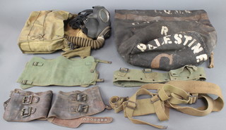 A no.4 Mk1 service respirator and case, a pair of webbing gaiters, a webbing belt, 2 webbing straps, pair of leather gaiters and a canvas kit bag  