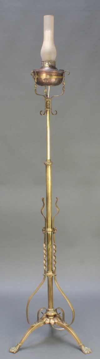 An Art Nouveau copper and brass standard oil lamp with copper reservoir and opaque glass chimney 