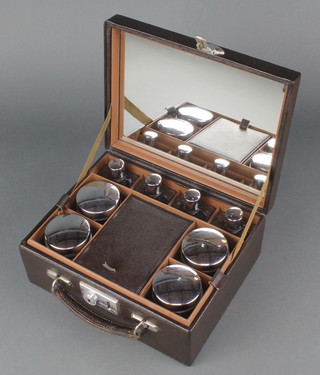 A 1930's/40's lady's travelling vanity box the interior fitted a mirror and various bottles contained in a  brown leather case with hinged lid 4" x 10" x 7 1/2" 
