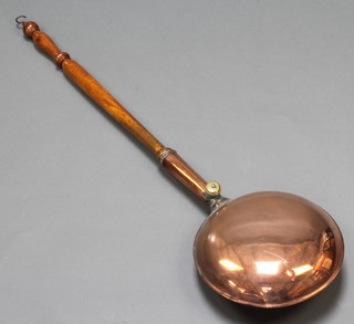 A Victorian copper warming pan with turned wooden handle 