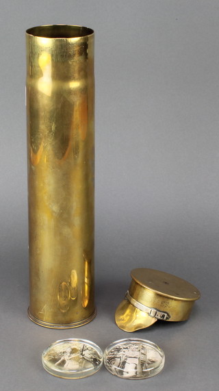 A Trench Art model of a cap marked souvenir Ypres 1914-1919 formed from a 1917 brass shell case together with an associated brass shell case the base marked 75 DEC PD DS15541 18R and 2 1930's glass paperweights decorated photographs of girls 3"  