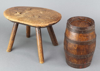 An oak coopered barrel 8" x 4" together with an oval elm stool raised on 4 turned supports (some old worm) 7" x 11" x 7 1/2" 
