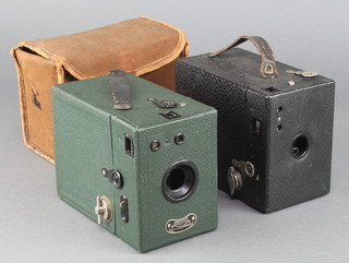 A Coronet portrait lens box camera contained in a green fibre case (shutter appears to be stuck) together with a Kodak no.120 box camera in a black case with fabric carrying case
