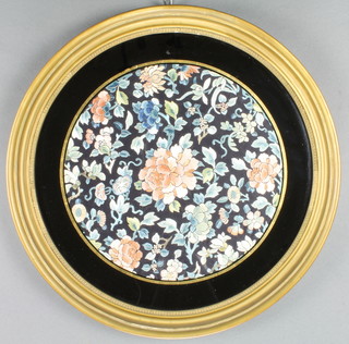 A circular Chinese silk embroidered panel 11" contained in a black and gilt frame